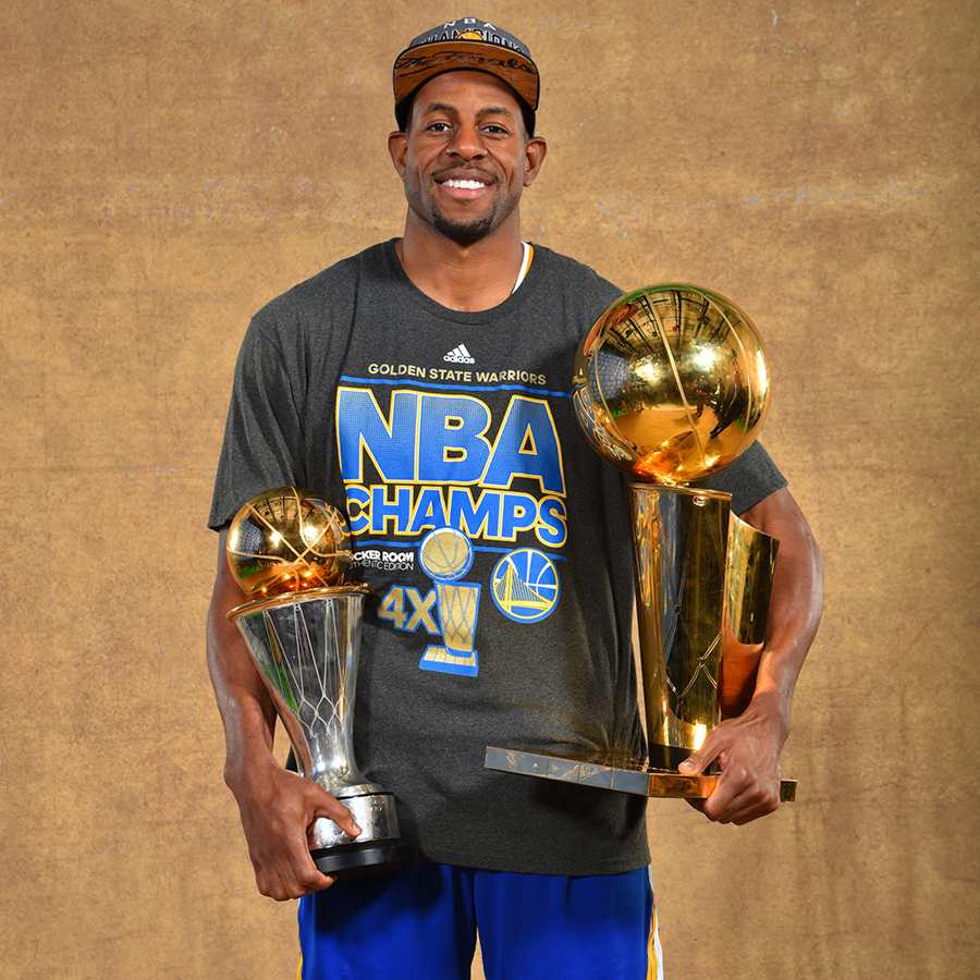 Andre Iguodala holds his first NBA title in 2015