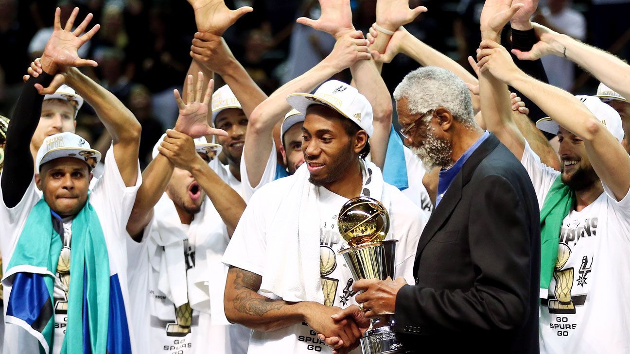 The San Antonio Spurs holding up the Larry O'brian trophy in 2014