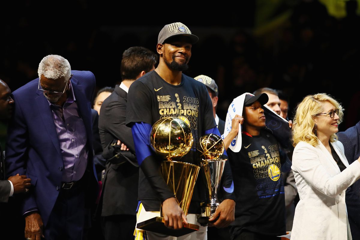 Kevin Durant holds his second Finals MVP and trophy in 2018