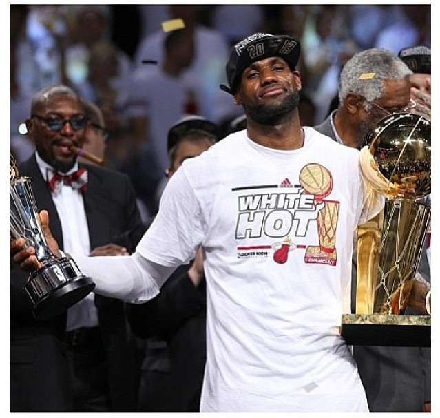 Lebron holding up his second Finals MVP trophy