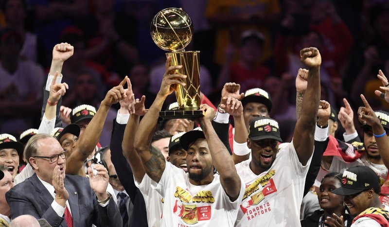 The Toronto Raptors all celebrate winning the championship in 2019